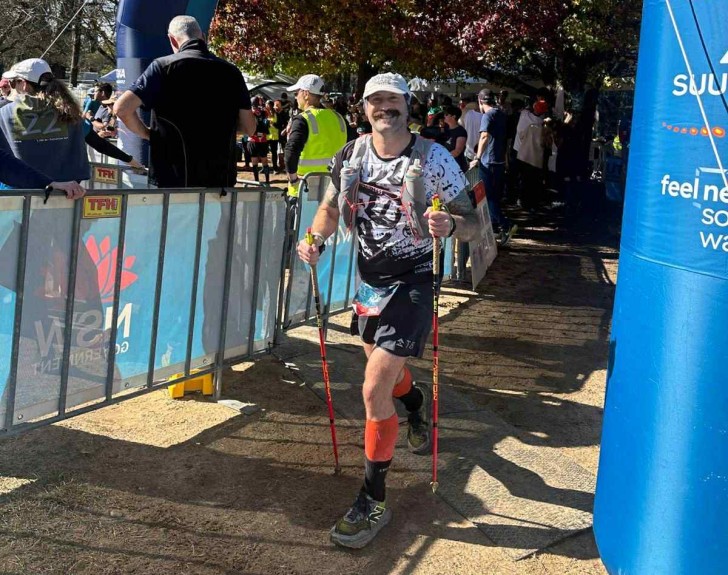 Mark Baker smiling at the camera while competing in one of his ultramarathon events.