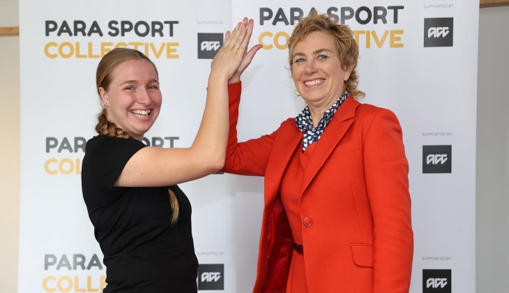 Megan Main high fives Para cycling athlete Siobhan Terry. 