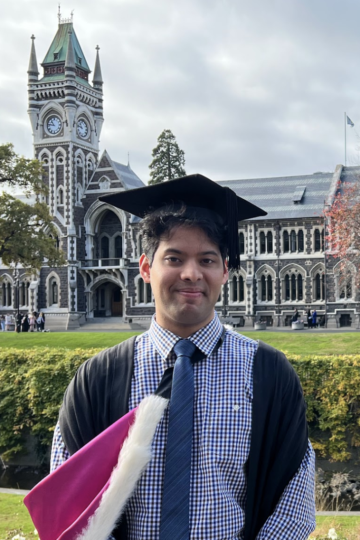 merrick rodrigues main image Merrick Rodrigues posing for a photo in his graduation clothing.