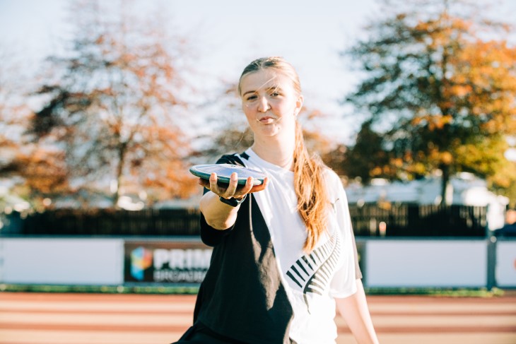 A portrait photo of Milly Marshall-Kirkwood holding her discus out towards the camera. 