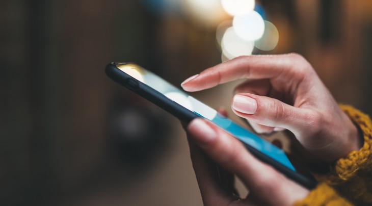 A woman typing on her mobile phone. 