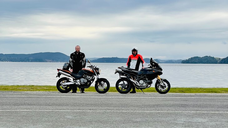 Nick Grant standing with his father and their motorbikes. 