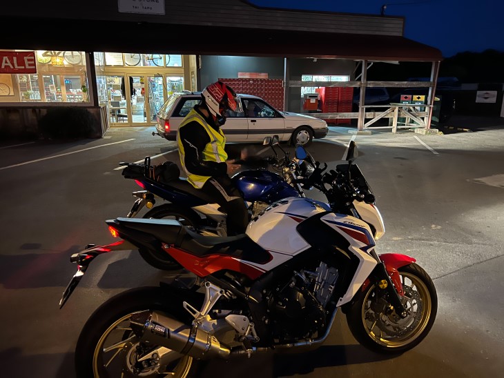 Sean Dickey sitting on his motorbike with another motorbike next to him. 