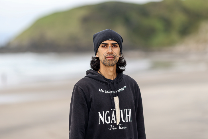 Nikau Munroe-Rawiri stands on a beach near his home in Northland. 