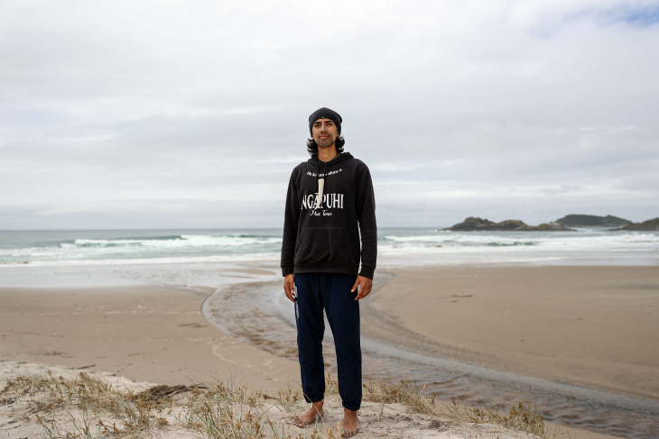 Nikau Munroe-Rawiri standing on the top of a dune. 