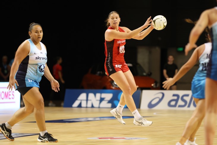 Netball player Paris Lokotui catches the ball in a game. 