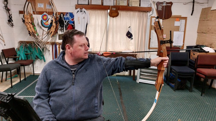 paul wallace 1 Paul Wallace using his bow to shoot an arrow.