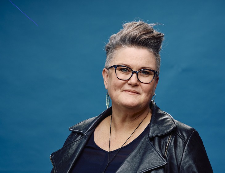 A portrait photo of Rachel Harrison in front of a blue background.