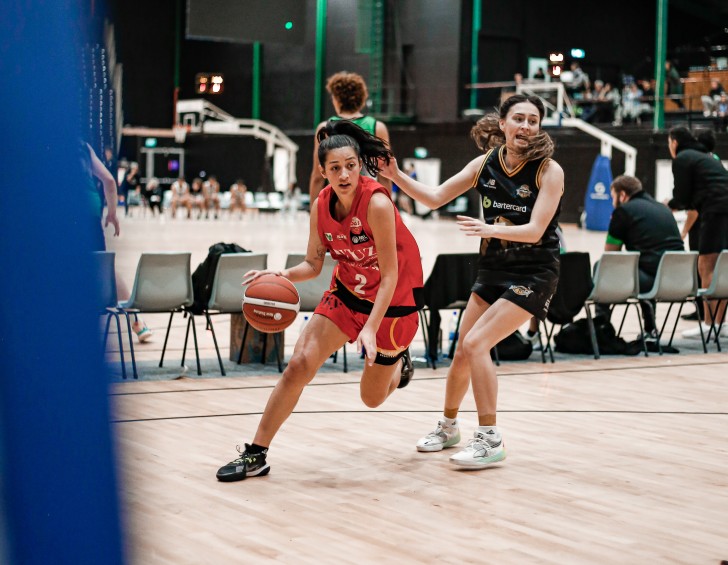 Riva Pitman dribbling past an opponent with the ball.