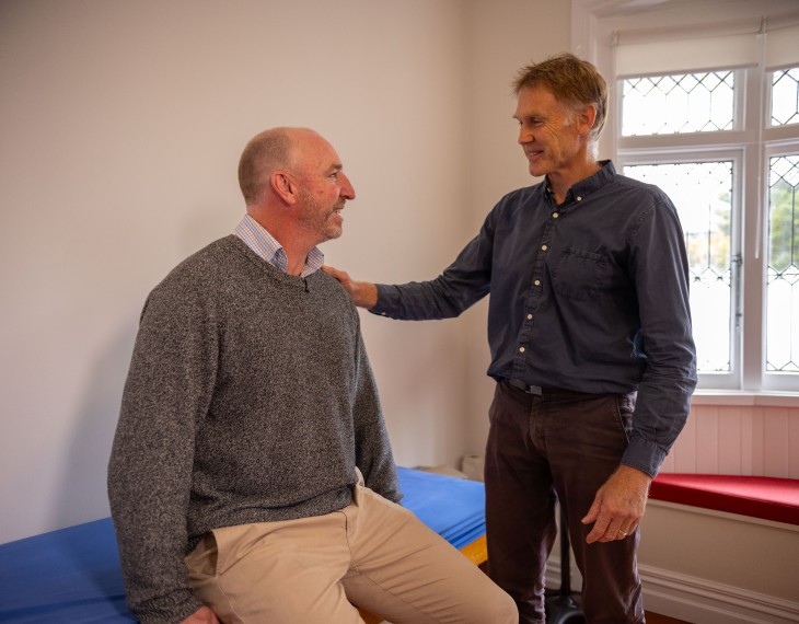 Dr Rod Nicholson assessing a patient in his clinic.