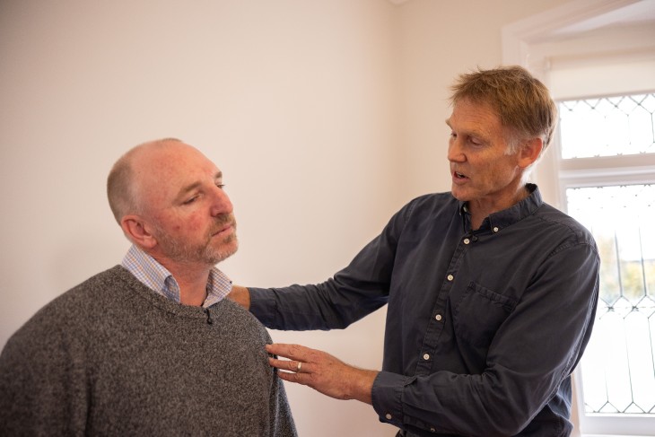 Dr Rod Nicholson assessing a patient in his clinic.