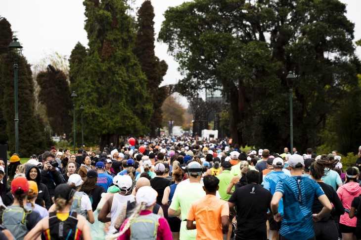 A crowd of runners shown from behind taking part in the Rotorua Marathon. 