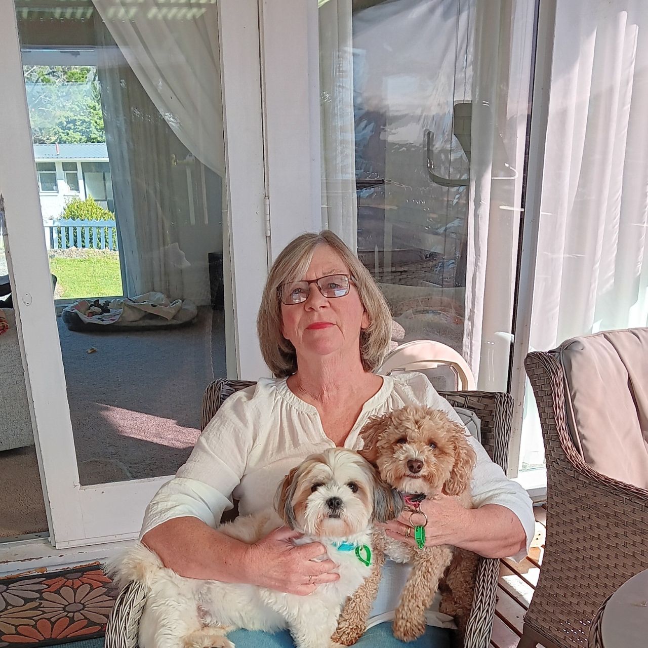 Sarah Pollard and her two dogs sat on a chair