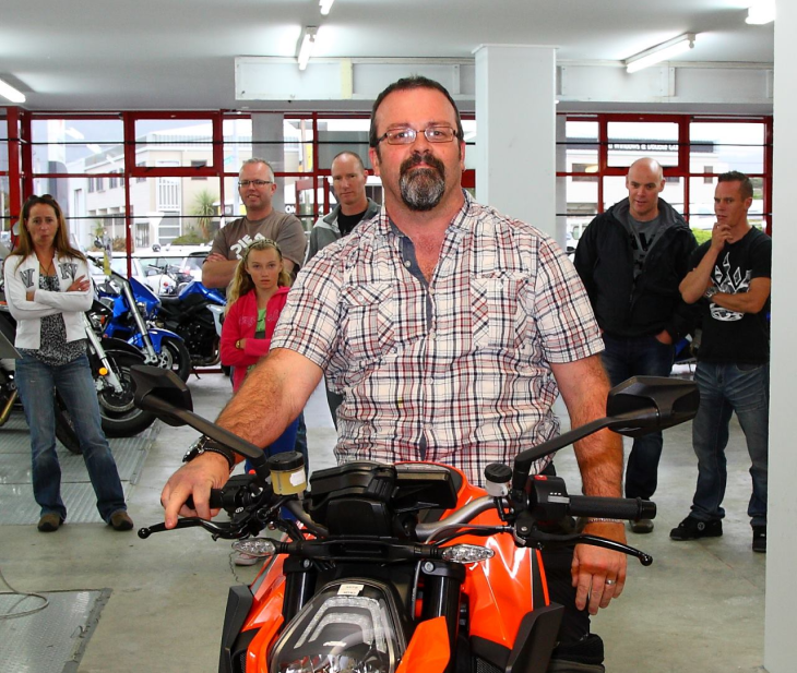 Simon Gotlieb sitting on his motorbike front-on with a serious expression.