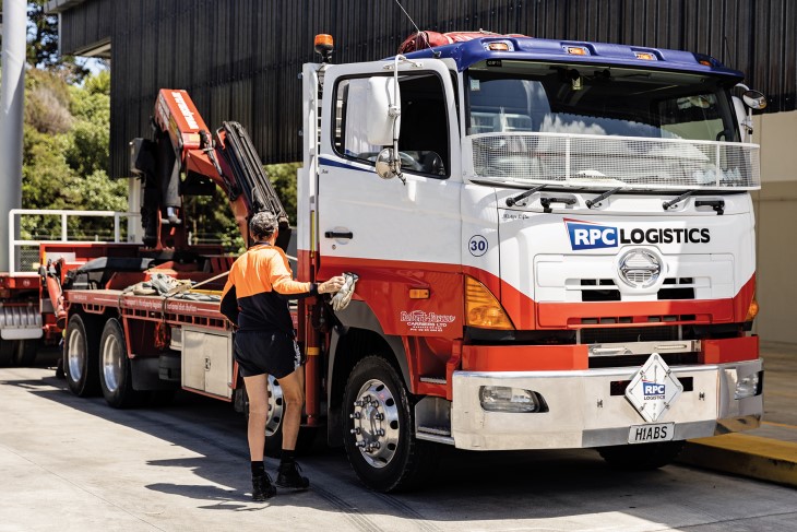 A man getting into a large truck. 