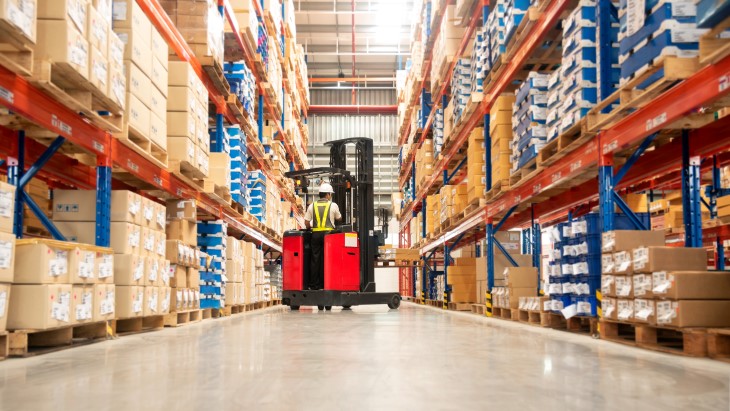 A forklift operator working in a factory. 
