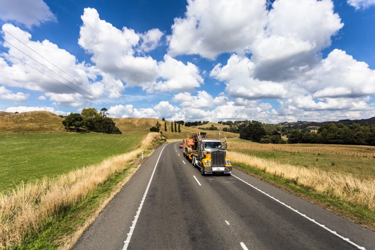 A large truck driving along a country road towards the camera.