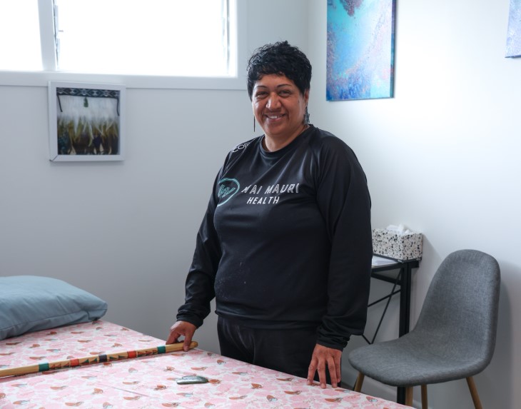 Wai Mauri Health founder Dale Wilson standing next to a bed in her practice.
