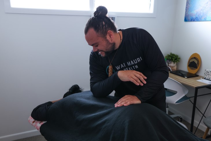 Wai Mauri team member Joshua Rameka using his healing methods on a client.