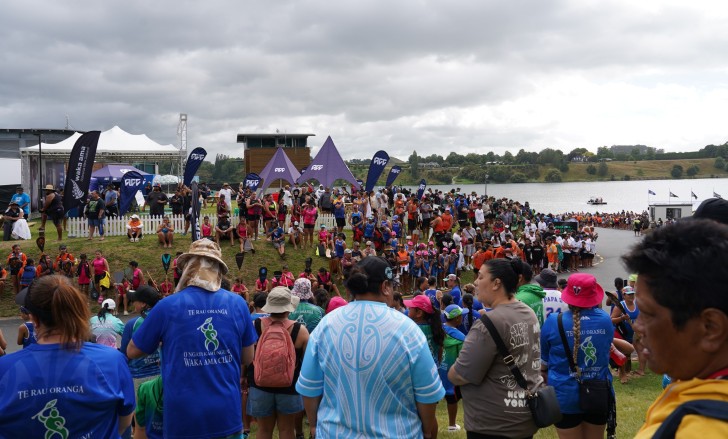 Crowds of people at the Waka Ama Sprint Nationals with ACC signage in the background.