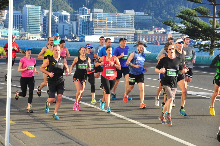 A group of people running along the waterfront in the Wellington Marathon.