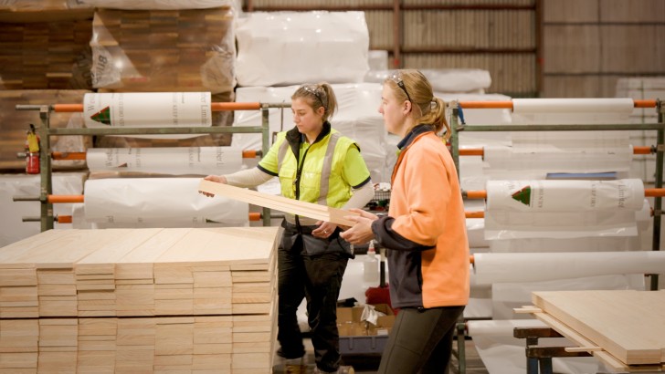 A pair of female colleagues working with timber at Westco Lumber.